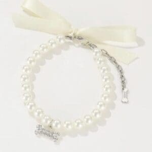 Elegant woman posing in chic floral dress.