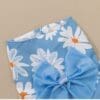 Blue floral fabric with large blue bow.
