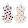Two polka dot dresses on mannequins.